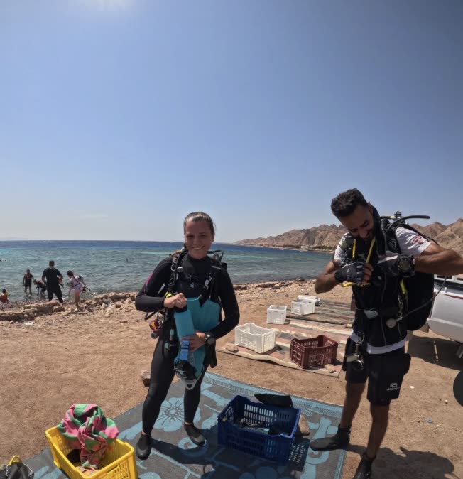 Divers kitting up on the beach before a shore dive.